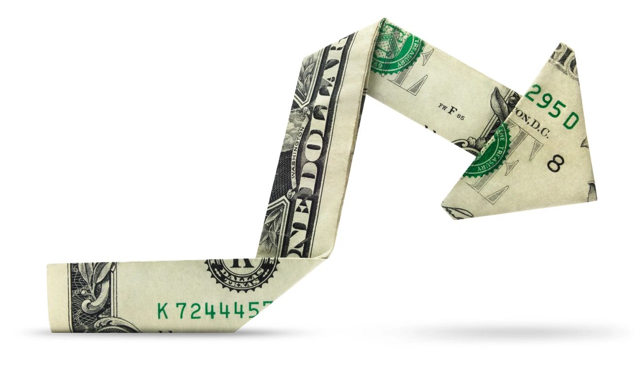 A dollar bill folded into the shape of an arrow.